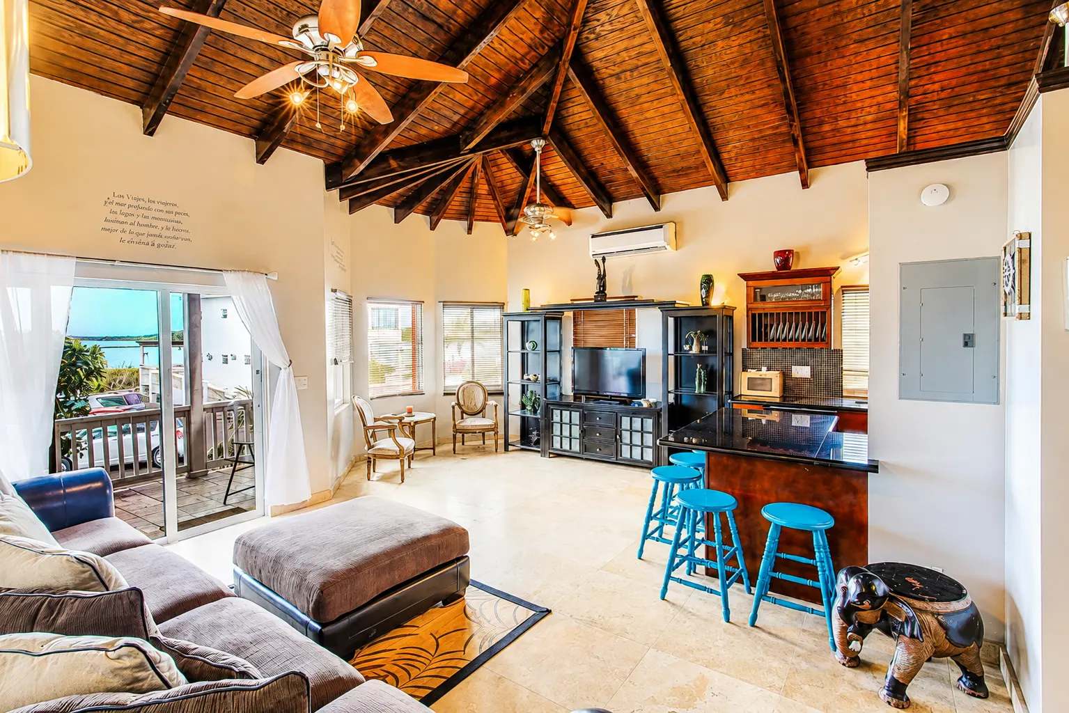 Living room with sofa, chairs and kitchen